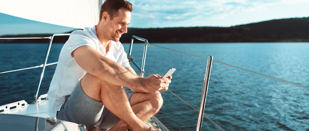 sitting on the bow on the phone