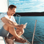 sitting on the bow on the phone