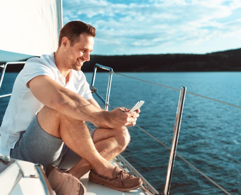sitting on the bow on the phone