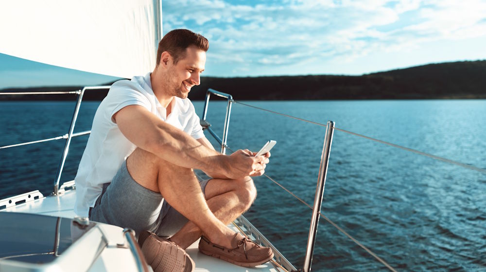 sitting on the bow on the phone