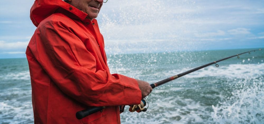 man in red jacket fishing