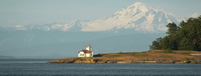 lighthouse with mountain in background